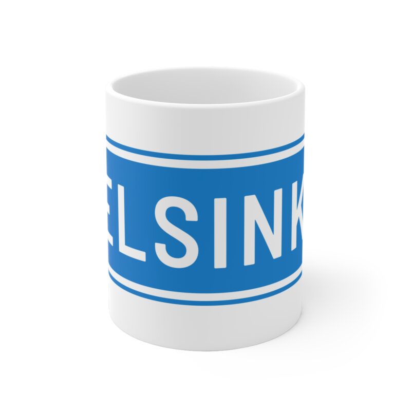 Ceramic coffee mug with minimalist blue and white directional sign reading “Helsinki”